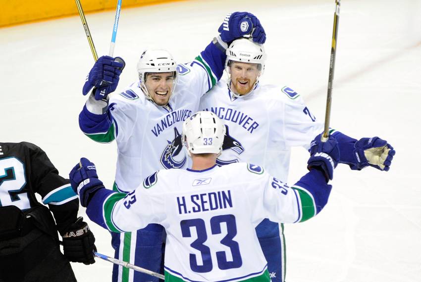 SAN JOSE, CA - MAY 22: (L-R) Alex Burrows #14, Henrik Sedin #33 and Daniel Sedin #22 of the Vancouver Canucks celebrate Burrows' goal in the third period against the San Jose Sharks in Game Four of the Western Conference Finals during the 2011 Stanley Cup Playoffs at HP Pavilion on May 22, 2011 in San Jose, California. The Canucks defeated the Sharks 4-2. (Photo by Thearon W. Henderson/Getty Images)